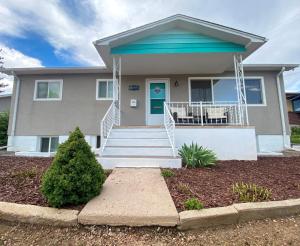 a house with a blue door and stairs at One Blue Rose in Colorado Springs