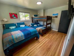 a bedroom with two beds and a bunk bed at One Blue Rose in Colorado Springs