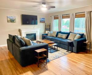 a living room with two blue couches and a fireplace at One Blue Rose in Colorado Springs