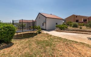 a backyard with a swing and a house at Luxe Holiday Home in Posedarje
