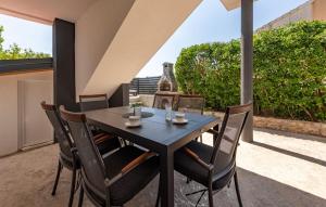 a black table and chairs on a patio at Luxe Holiday Home in Posedarje