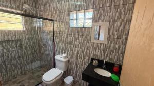 a bathroom with a toilet and a sink and a shower at Recanto da Paz - Monte Verde in Monte Verde +17 photos