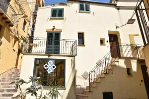 a building with a cross on the side of it at MEITHRAS holiday homes in Agrigento