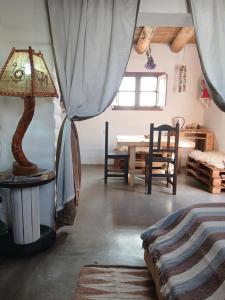 a living room with a table and a lamp at Pacha Wasi in Humahuaca