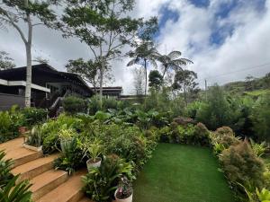a garden with a green lawn in front of a house at Casa Brisa Resort in Kayagan