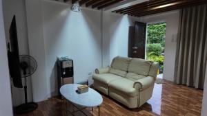 a living room with a couch and a table at Casa Brisa Resort in Kayagan
