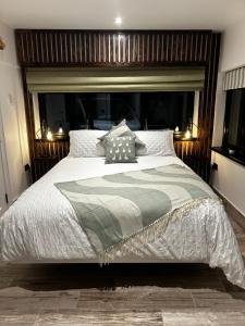 a bedroom with a large bed with a wooden headboard at Springvale Lodge in Castlerock