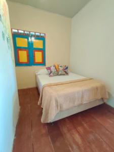 a bedroom with a bed with a painting on the wall at Bosque De Niebla Casa Rural in La Florida