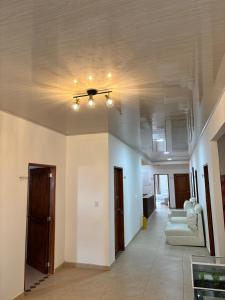 a living room with a ceiling fan and couches at Hotel Mevak boutique & Spa in Ciénaga de Oro