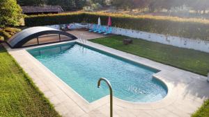 a swimming pool in a yard next to a backyard at Casa dos Trigais in Marco de Canaveses
