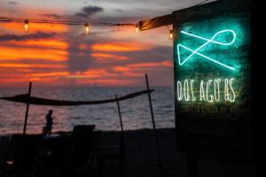 a sign on the beach with the ocean in the background at Dos Aguas Lodge in Rincón