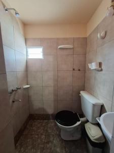a bathroom with a toilet and a sink at Hostal El Zorrito in Iruya