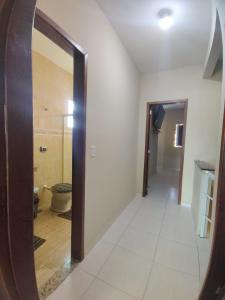 a hallway with a mirror and a toilet in a room at Casa INDEPENDENTE 4 QUARTOS VILA DO PERÓ CABO FRIO in Cabo Frio