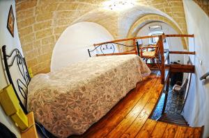オーリアにあるcasa vacanze Filomenaのレンガ造りの部屋にベッド1台が備わるベッドルーム1室が備わります。