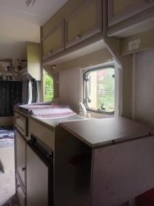 a kitchen in an rv with a counter top at Camping -Dor de Munte -Ceahlau in Bistricioara +56 photos