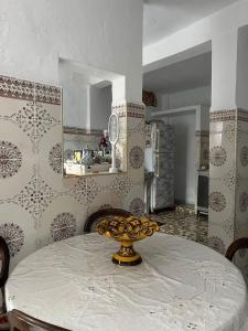 a kitchen with a table with a bowl on it at Maison Ghali in Safi +6 photos