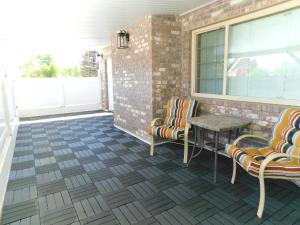 a patio with chairs and a table and a window at Copper Queen Hotel & Casino in Ely