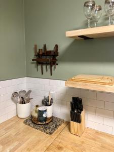 a kitchen with a counter with utensils in containers at Peaceful, cozy cabin in the woods in Murphy