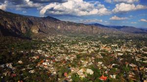 an aerial view of a city in the mountains at Hostal Casa Petricor  +1 photo
