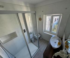 a bathroom with a shower and a sink and a toilet at Vila Dida Suites City Centar in Split