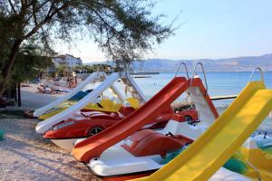 a row of slides on a beach near the water at Apartments with parking space Slatine, Ciovo - 16732 in Slatine