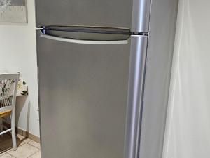 a stainless steel refrigerator in a kitchen at Gîte de Charme près du Mans avec Piscine et Climatisation - FR-1-410-381 in Changé