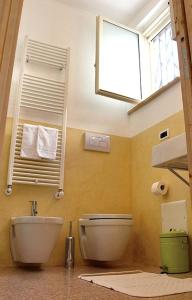 a bathroom with a toilet and a sink and a window at Rosa dei Venti in Tricase