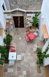 an overhead view of a patio with red chairs and a table at Rosa dei Venti in Tricase