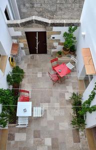 an overhead view of a patio with red chairs and a table at Rosa dei Venti in Tricase +9 photos