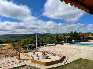 a villa with a swimming pool and a resort at Hotel Fazenda Brisa dos Gerais in Palmeiras