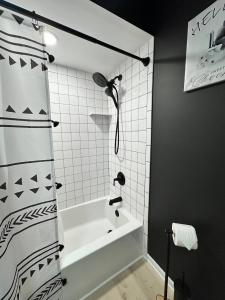 a bathroom with a bath tub and a shower at Blessed Beyond Measure King with Ensuite in Norwalk