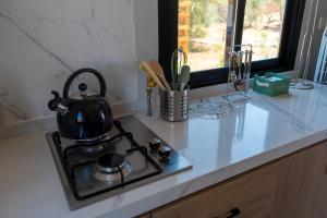 a black tea kettle on a stove in a kitchen at Luna de Chañares in San Pedro de Atacama