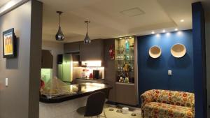 a living room with a blue wall and a chair at Sobrado PEREIRA E LOBATO in Belém