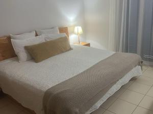 a bedroom with a large bed with white sheets and pillows at Sol & Lar No stress in Santa Maria +93 photos