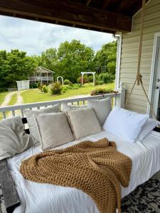 a bed on the back porch of a house at The Lookout House at The Bluebird in Eureka Springs