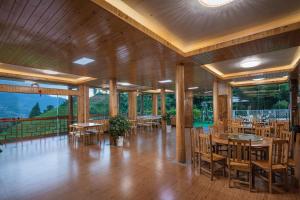 a dining room with tables and chairs in a building at happy live hotel in Heping