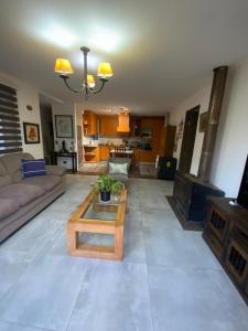 a living room with a couch and a coffee table at Casa lago rapel in Lago Rapel