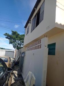 a white building with a fence next to a car at Seu lar in São José