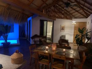 a living room with a table and a couch at Villa Agualimpia in Puerto Ángel