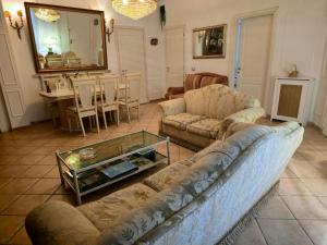 a living room with a couch and a table at Il Bacio di Roma in Infernetto +17 photos