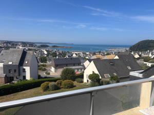 a view of a city from the balcony of a house at Vue mer exceptionnelle-Appartement cosy à Erquy in Erquy