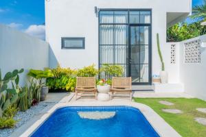 a swimming pool in the backyard of a house at Tropical Oasis Villa Private Pool Seseh beach in Seseh