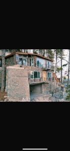 a large brick house with a staircase in front of it at Mushkpuri Terraces - Khaira Gali in Khaira Gali