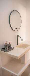 a bathroom with a sink and a mirror on the wall at Masaya Retreat Lombok in Kuta Lombok