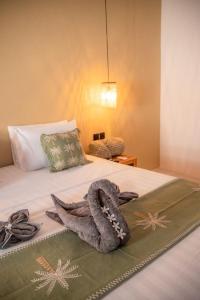 a bedroom with a bed with a towel on it at Masaya Retreat Lombok in Kuta Lombok +38 photos