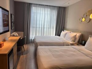 Ein Bett oder Betten in einem Zimmer der Unterkunft Orange Beijing Yanqing Badaling Great Wall Hotel