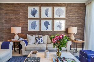 a living room with a couch and flowers on a wall at Ocean View Penthouse 1326 at Bells Boulevard in Kingscliff