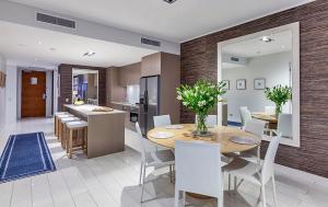 a kitchen and dining room with a table and chairs at Ocean View Penthouse 1326 at Bells Boulevard in Kingscliff