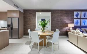 a kitchen and dining room with a table and chairs at Ocean View Penthouse 1326 at Bells Boulevard in Kingscliff +26 photos
