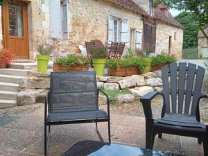 two chairs sitting in front of a house at Maison de Charme avec Jardin, Activités de Plein Air et Proche Sites Touristiques - FR-1-616-333 in Tourtoirac